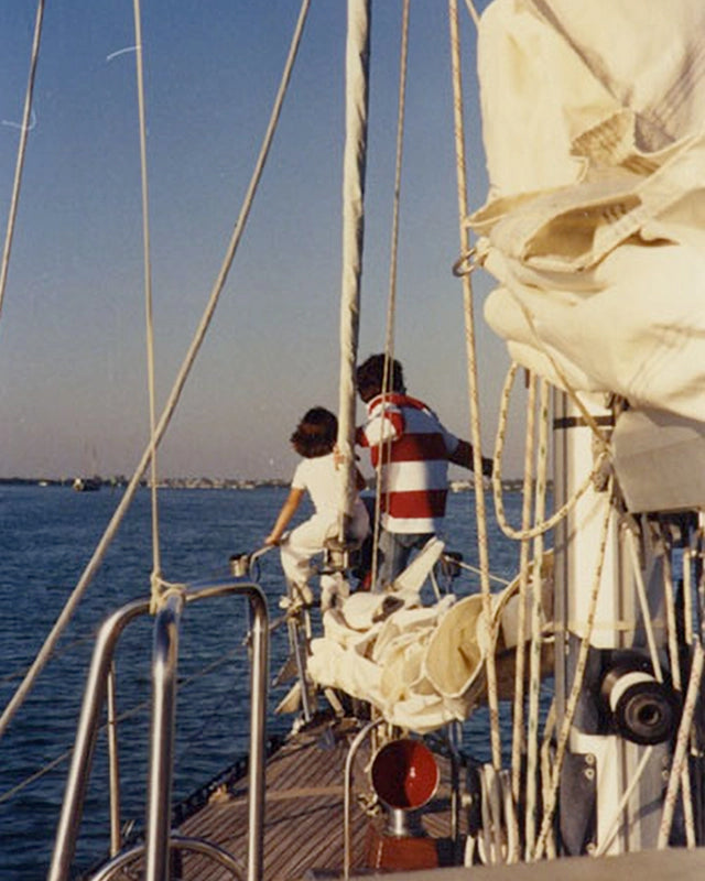 Michelle and her dad on their boat looking out over the water
